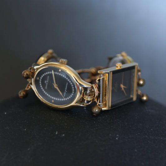 Gold watch with two different face designs on a dark background